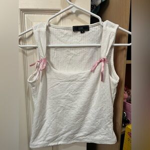 White top with pink ribbon bows